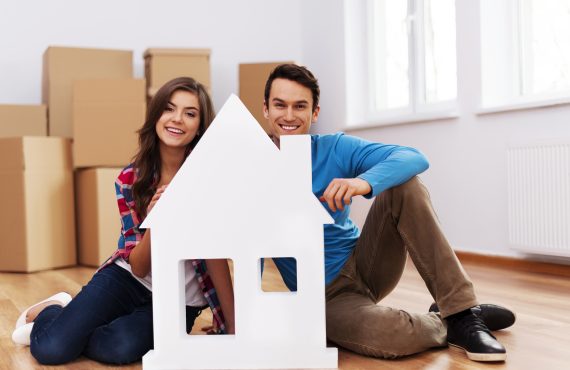 young-couple-with-house-sign-570x370